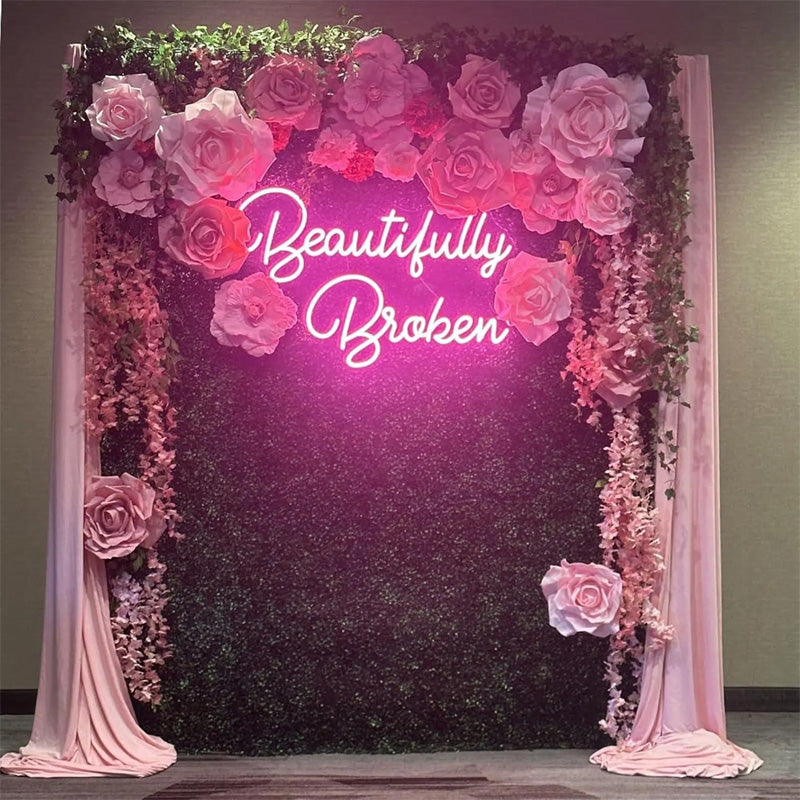 BeautifullyBroken_NeonSign_PinkLEDTextNeonQuoteforWedding_Event_FloralBackdrop.jpg